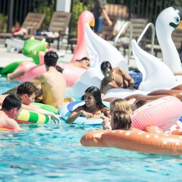Students on floaties at the pool
